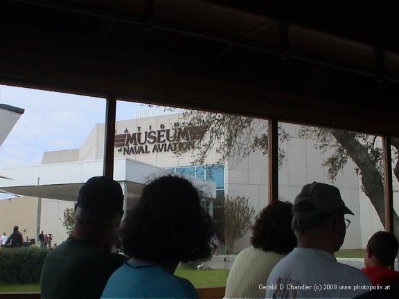 Tour bus passing Naval Aviation Mumeum entry